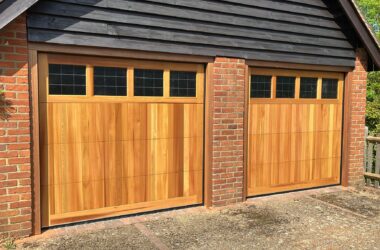 Sectional wooden garage door in a warm wood-tone finish, offering both beauty and durability.