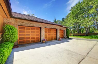 A modern home with row of matching brown up-and-over garage doors.