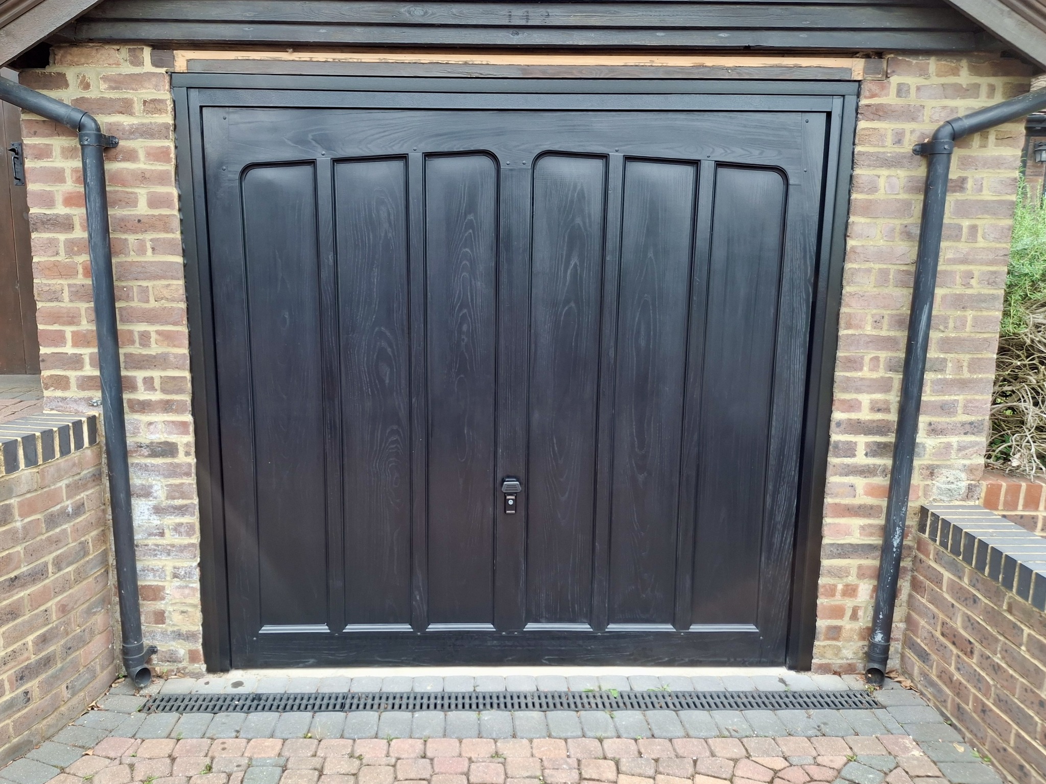 GRP Garage Door After East Grinstead Manufacturer: CDC Garage Doors Door Type: Up and Over Door Style: The Ashtead Door and Frame Colour: Black