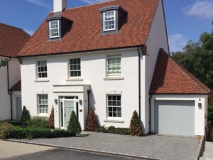 Diagonal Shot of White House with Verwood Agate Grey Garage Door